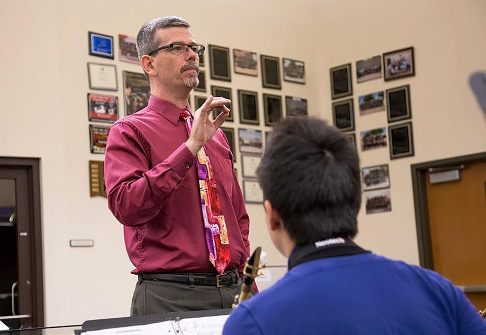 Photo by Nick Park 15 -- New band director Mr. Leo Werner conducts students during Sept. 15.