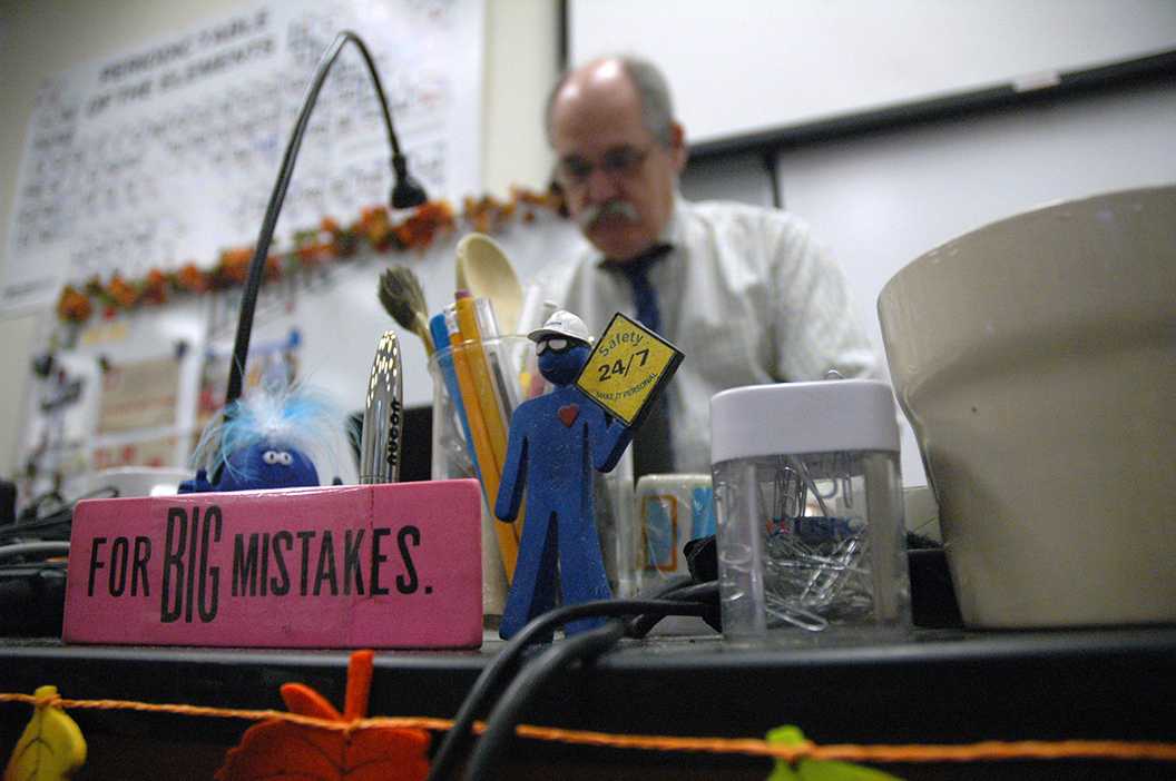 Photo by Cory Wyman 16 - Oct. 8, Mr. Burke sets up for class in the morning. His desk is filled with a variety of trinkets that give it a unique, interesting character.