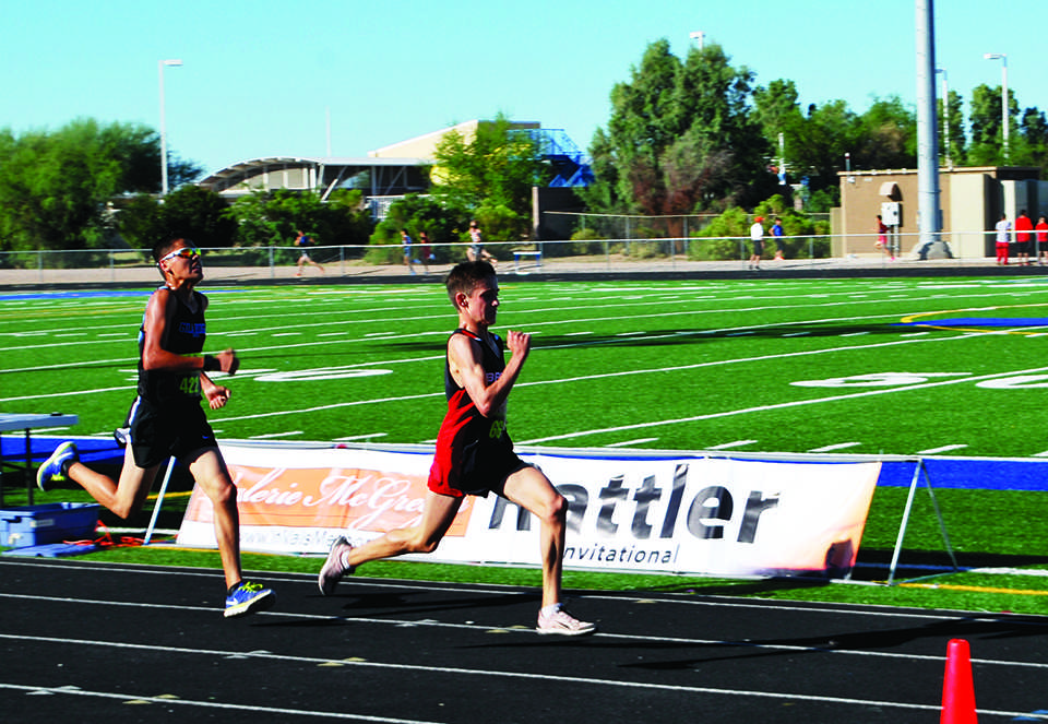 Photo by Luke Mailliard 15 -- Cross country runner Luke Mason 17 sprints ahead of a Gilbert High School runner.