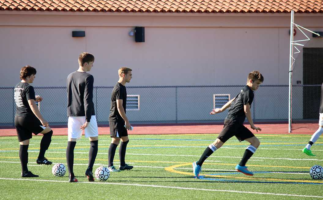 Photo by Bryce Owen ’17 - The soccer team takes shots on goal at practice Nov. 11. The team looks to make a big impact with many young players this year.