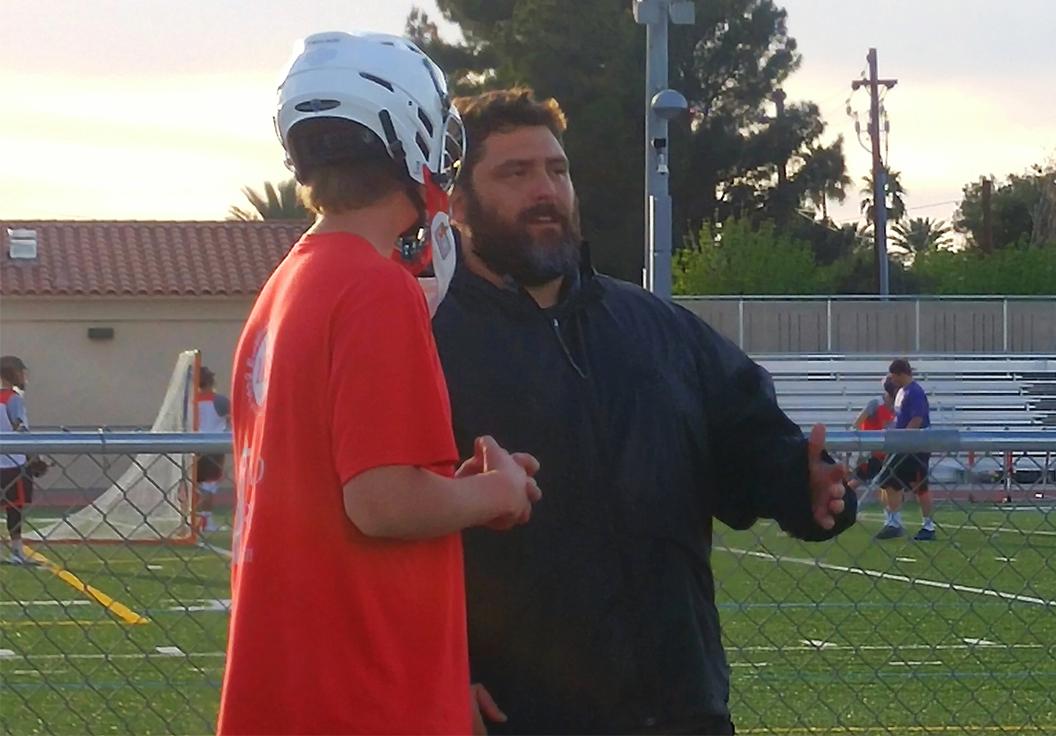 Photo by Devin McManimon McNally ’17 - Mr. Chris Agliano instructs a player during Lacrosse practice Monday, March 7. Mr. Agliano coaches in the lacrosse, basketball and football programs.