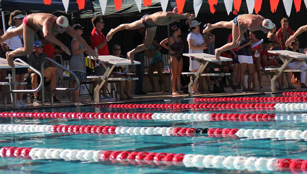 Photo by Andrew Brown ’18 | Brophy swimmers leap into the pool to begin a freestyle race.