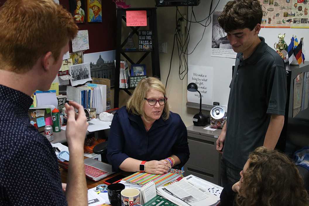 Photo by Bryce Owen ’17 | Mrs. Venberg speaks with students at lunch discussing global affairs.