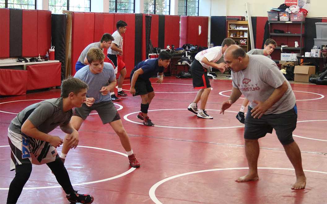 Photo by Bryce Owen ’17 | Mr. Wayne Catan practices stances with the wrestling team Nov 7.