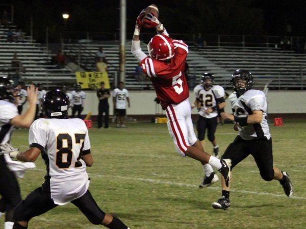 Photo by Andrew Ahearne '11 - Brophy's Fred Gammage '12 leaps for a pass between Gilbert defenders Sept. 3.