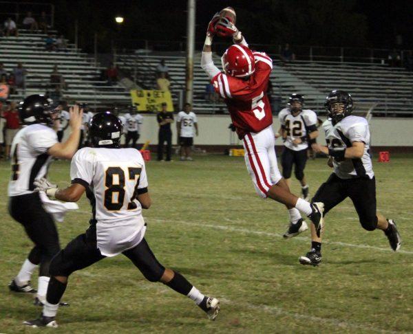 Photo by Andrew Ahearne '11 - Brophy's Fred Gammage '12 leaps for a pass between Gilbert defenders Sept. 3.