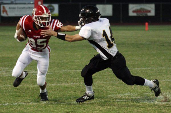 Photo by Rob March '11 - Brophy's Devon Allen straight arms a Gilbert defender in the first quarter Sept. 3.