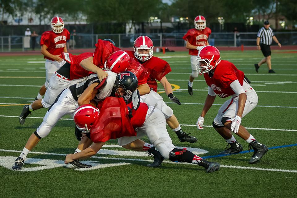 Photo by Ben Liu 15
Brophy defenders wrap up a Liberty runner Aug. 13. Brophy played against Peoria Libertyin a pre-season scrimmage at the Brophy Sports Campus.