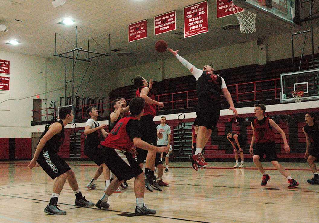 Photo by Cory Wyman 16 |  rederick Erlandson 15 reaches for the ball as the varsity Basketball team practices after school Nov. 6. 