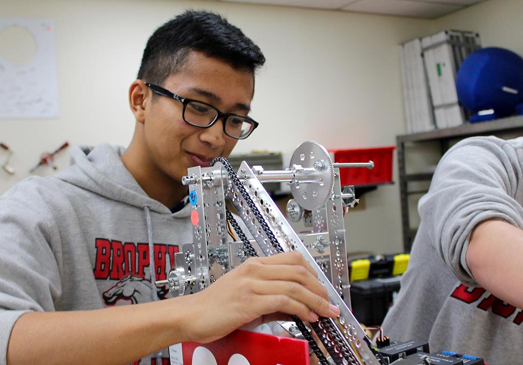 Photo by Devin McManimom McNally 17 - Bryan Vo 15 works on a robot in room K14, Dec. 9, 2014. Robotics has become recognized as an official high school sport as of late 2014.