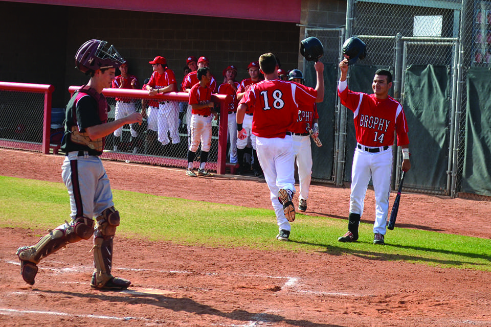 Photo by Alec Vick 15 -- Adrian Zubia 15 salutes Chad McLanahan 16 with his helmet after McLanahan hit a home run against Red Mountain on Apr. 24