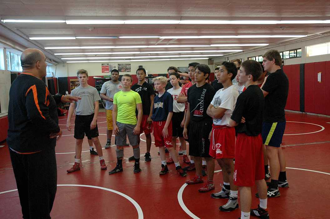 Photo by Andrew Brown ’18 - Mr. Wayne Catan speaks to the wrestling team before practice. The team has a new coach and mindset as the season approaches.