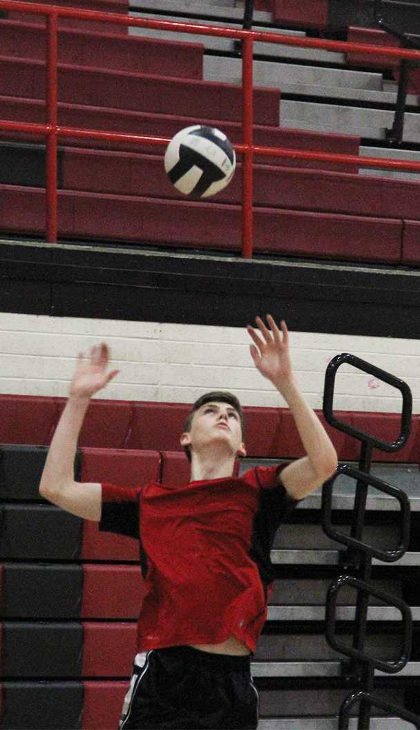Photo by Andrew Brown ’18 - Connor Dunn ’18 practices his serve March 3. This is the second year that Dunn has made the transition from basketball to volleyball.