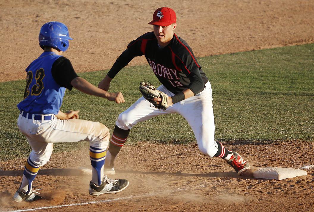 Photo by Hunter Franklin ’19 - Chad McClanahan ’16 tags out a base runner during the baseball game against North Canyon Friday, Feb. 26. The team looks to build off of experience heading into the season.