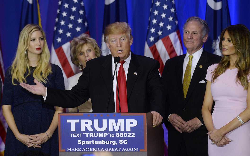 Photo Courtesy of Tribune News Service - Republican presidential candidate Donald Trump, flanked by his daughter Ivanka, left, and his wife Melania Trump, speaks during a primary watch party at the Spartanburg Marriott on Feb. 20, 2016 in Spartanburg, S.C.