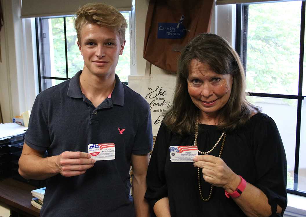 Photo by Bryce Owen ’17 | Greyson Beck ’17 and Ms. Susan Maynard show off voter ID cards.