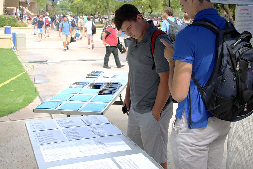 Photo by Bryce Owen ’17 | Students and faculty gather to look at the Advocacy club’s expo on political candidates.The advocacy club put created an expo showcasing political candidates and their alignment with church teachings.