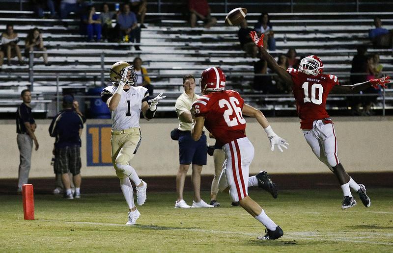 Brophys Denzel Burke (10) and Sully Shannon (26) attempt to intercept a pass intended for Desert Vistas wide receiver Jake White (1) in a high school football game against Desert Vista Friday, Sept. 15, 2017, in Phoenix. Desert Vista defeated Brophy 17-14. (The Roundup/Hunter Franklin