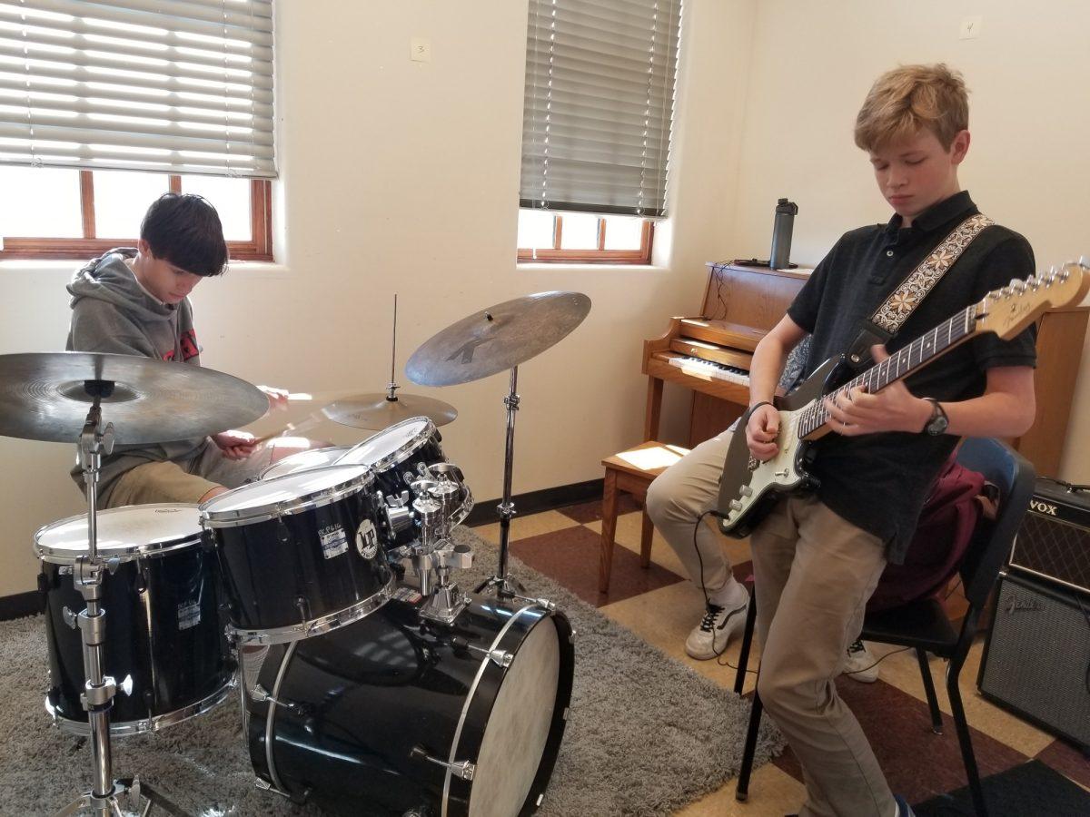 Norman Hall 23 (Right) and Will Hall 23 perform one of their singles in an Eller practice room. The duo practices in that room multiple times a week to keep improving their musical capabilities. Photo credit: Mark Rossbach
