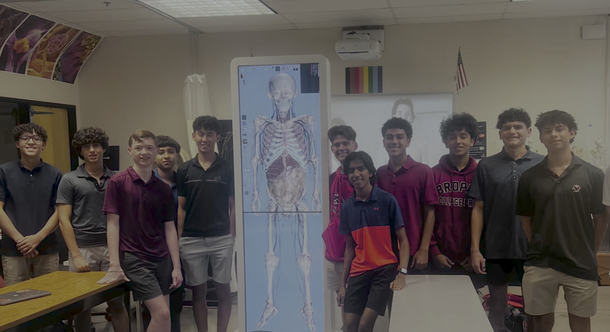 Students pose with Anatomage machine, one of the many pieces of equipment ASU will have