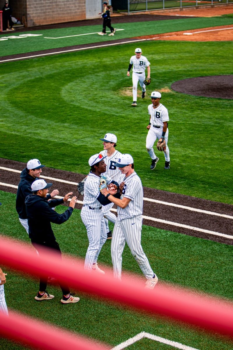 Outfielder Dennis Gregory '25 celebrates with pitcher Jack Lafflam '25 after a diving effort got the last out of the inning vs Sandra Day O'Conner on March 14th, 2025