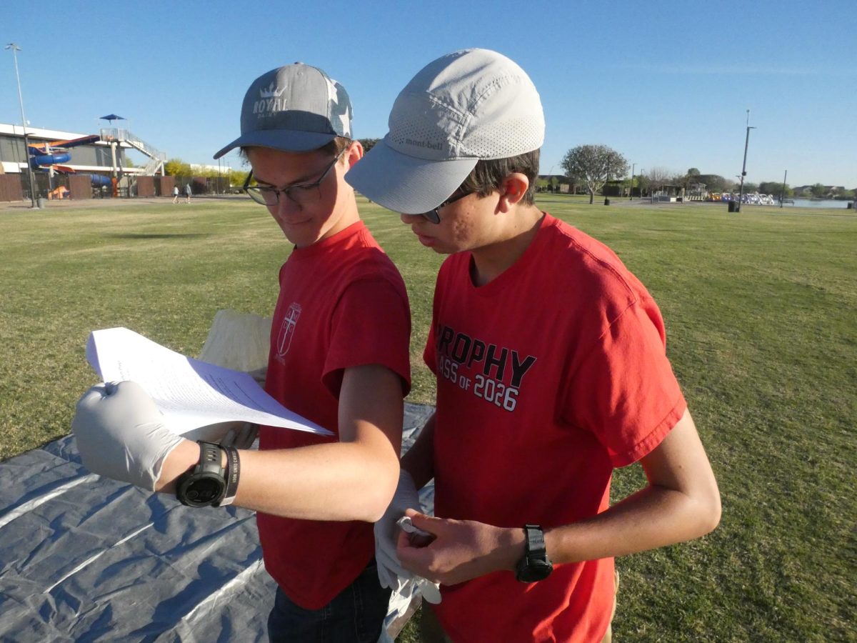 Shane Smith ’26 (left) and Lucas Vargas ’26 (right) review the balloon-filling checklist. They have developed new techniques and equipment to ensure the successful filling of the balloon.