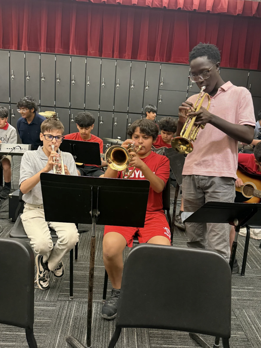 A group of Loyola Academy students practice their instruments during Note by Note practice.
